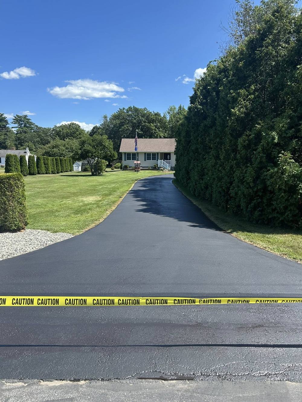 Sealcoated driveway with caution tape